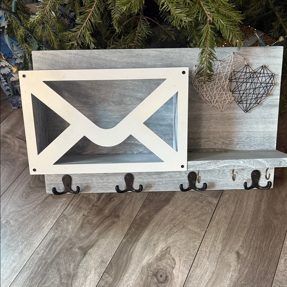 This is a wooden wall, mounted letter holder, keys holder, and coat holder